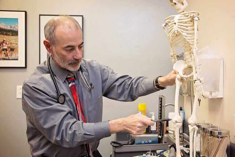 Dr. Robert lending pointing on skeleton