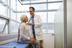 internal medicine Doctor performing a medical exam on patient