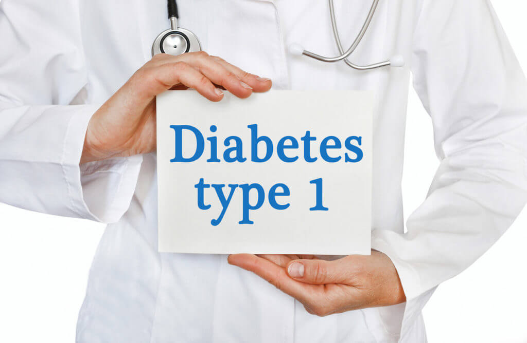 Image of a card with Diabetes Type 1 written on it, held by a medical doctor against a white background.