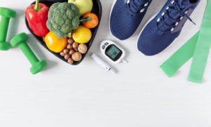 Healthy eating and sport plan for diabetes patients top view on white wooden table.